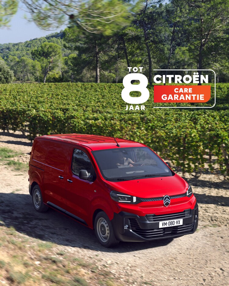 Three‑quarter front view of a red Citroën Jumpy driving on a rural road, showing robust design, driving comfort, versatility and confident presence.